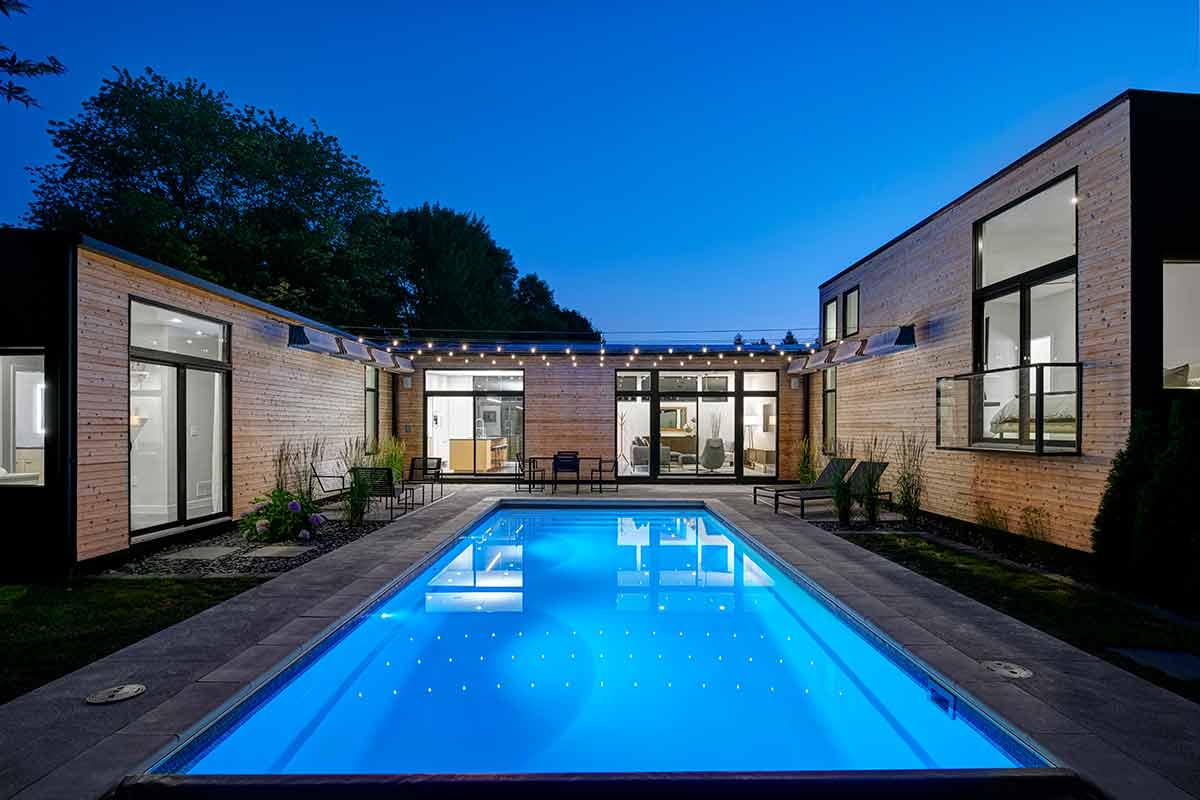 A contemporary home featuring a swimming pool and a spacious patio area for outdoor relaxation