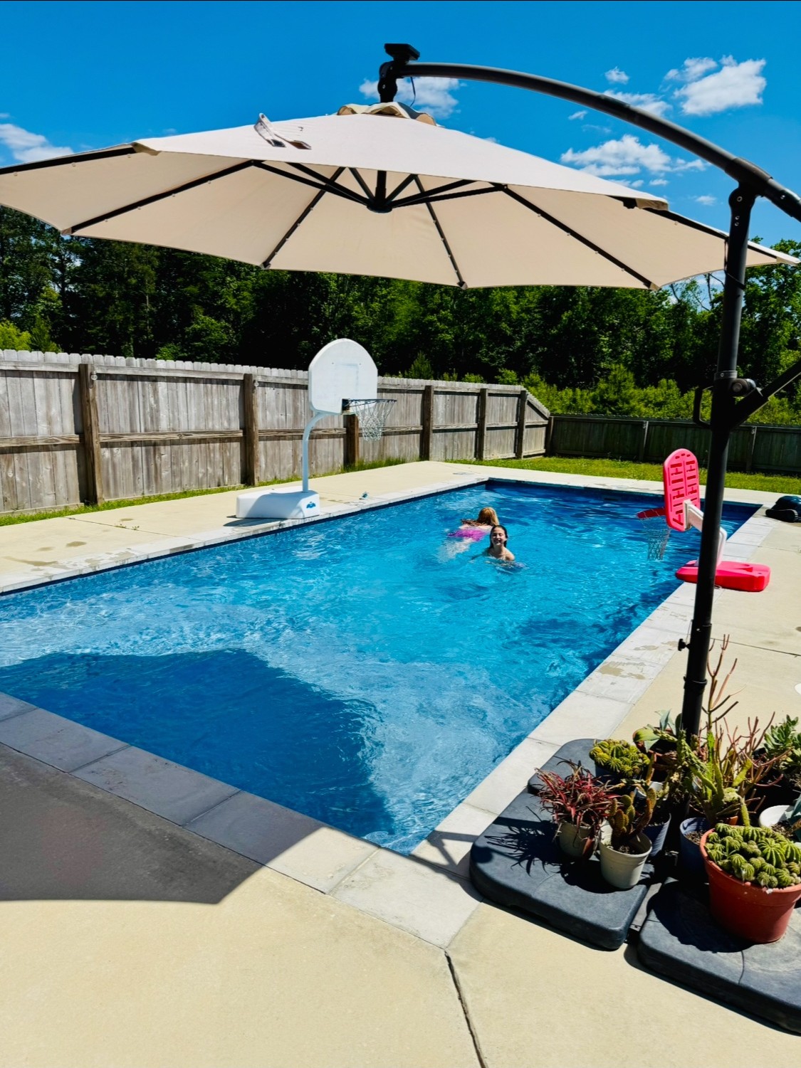 Finished Precision fiberglass pool in summer with swimmers